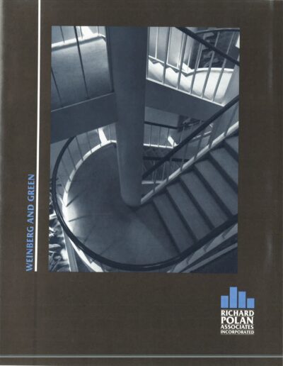 A monochrome photo of a spiral staircase within a building.